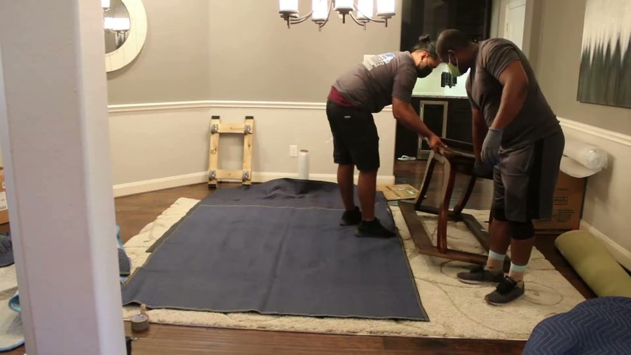 Crew blanket-wrapping furniture with care